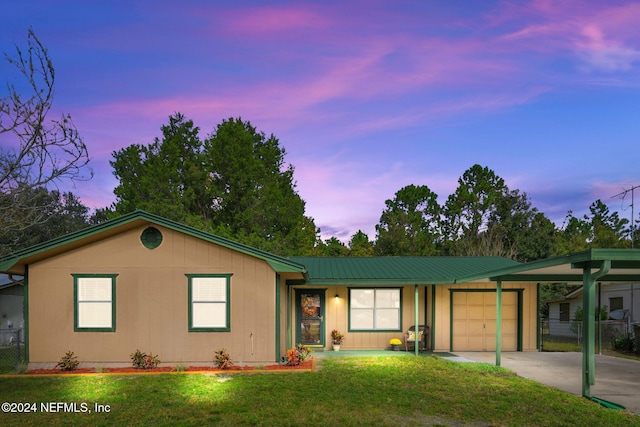 ranch-style home with a yard and a garage