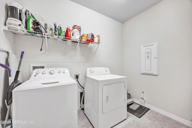 647 La Mancha Dr, Saint Augustine, FL 32086 - laundry area featuring washing machine and dryer, baseboards, a textured ceiling, and electric panel