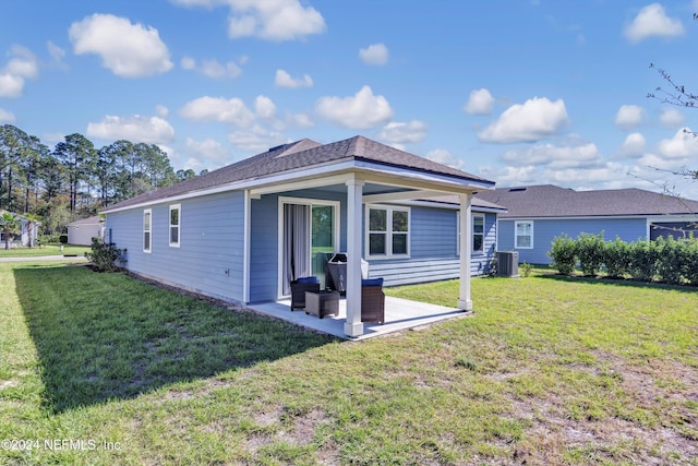 647 La Mancha Dr, Saint Augustine, FL 32086 - rear view of property with central AC unit, a lawn, and a patio area