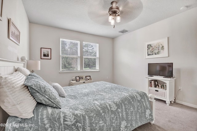 647 La Mancha Dr, Saint Augustine, FL 32086 - carpeted bedroom with baseboards, ceiling fan, and a textured ceiling
