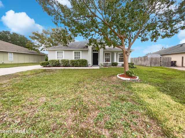 ranch-style house featuring a front lawn