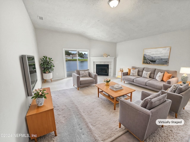 living room featuring a textured ceiling, carpet flooring, a tile fireplace, and vaulted ceiling