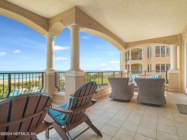 view of patio / terrace featuring a water view and a balcony