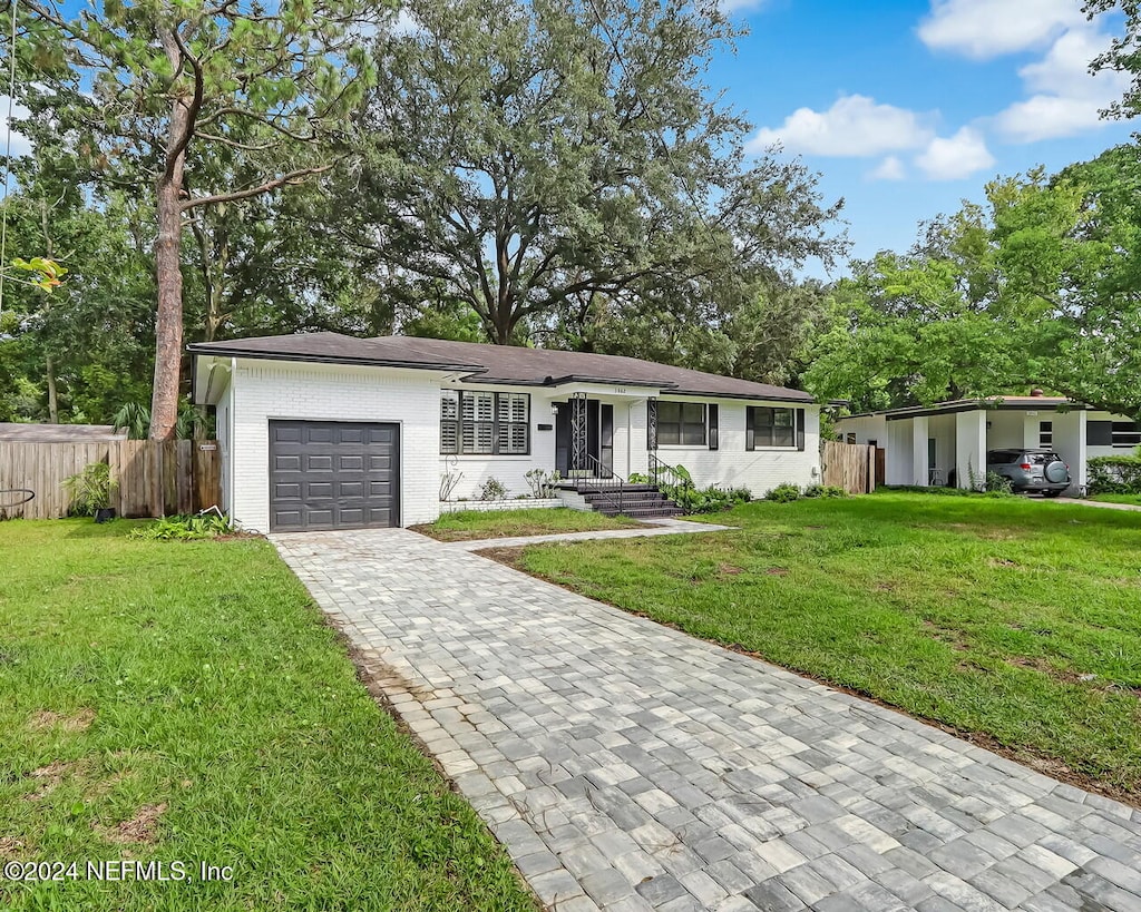 ranch-style house with a front yard and a garage