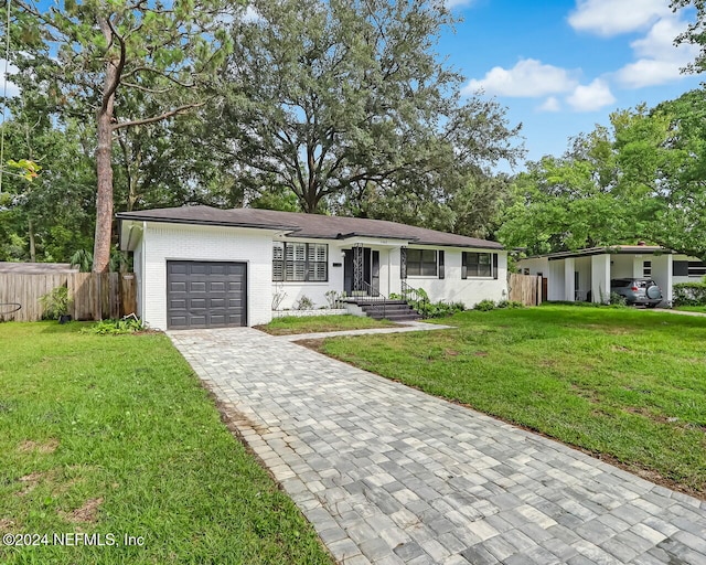 ranch-style house with a front yard and a garage