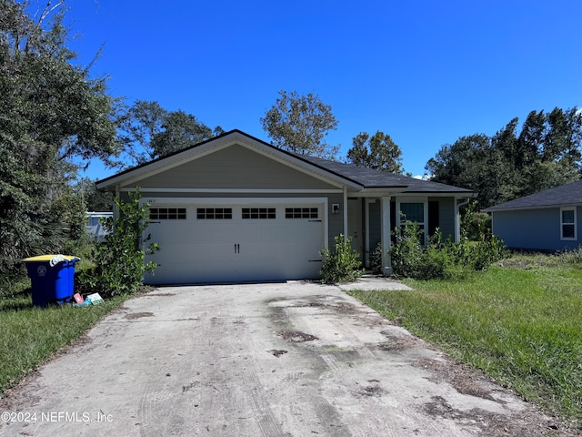 single story home with a front yard and a garage