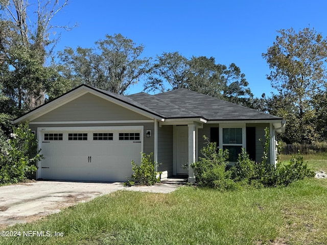 view of front of property with a front lawn and a garage