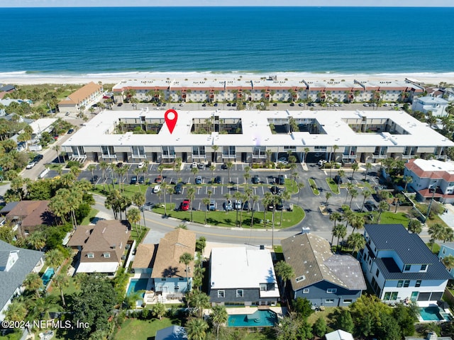 aerial view with a water view and a beach view