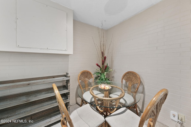 dining room with brick wall