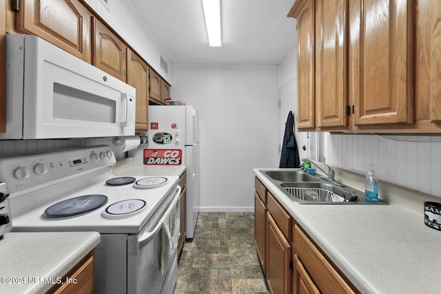 kitchen featuring sink and white appliances