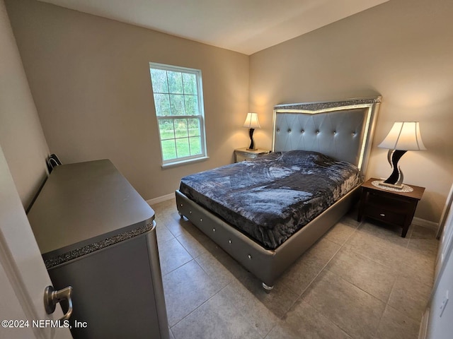 bedroom with light tile patterned floors