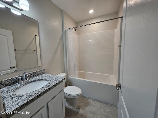 full bathroom featuring tile patterned floors, shower / bath combination with curtain, toilet, and vanity