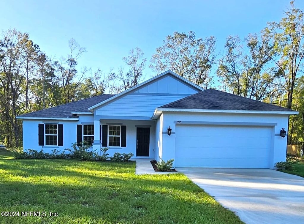 ranch-style home featuring a garage and a front lawn