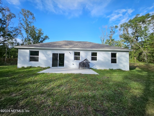 back of house featuring a yard and a patio