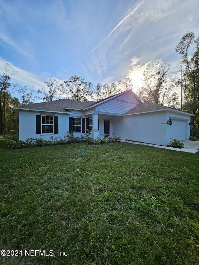 single story home with a lawn and a garage