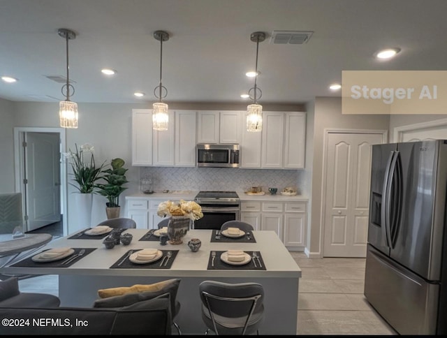 kitchen with pendant lighting, white cabinets, light tile patterned floors, tasteful backsplash, and stainless steel appliances