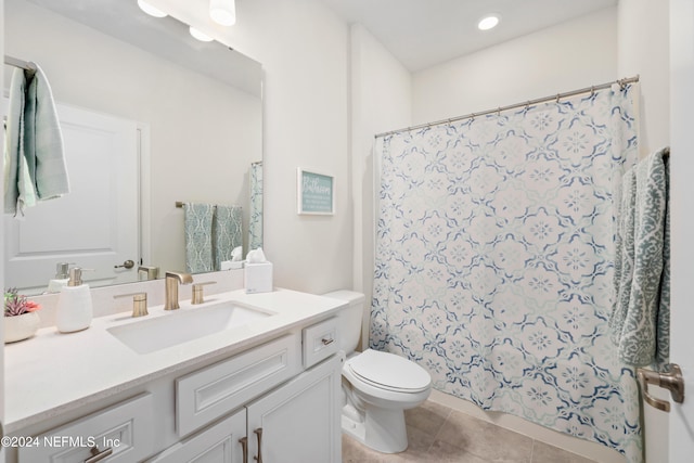 bathroom featuring toilet, walk in shower, vanity, and tile patterned floors