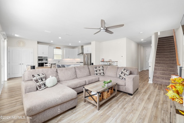 living room with ceiling fan and light hardwood / wood-style floors