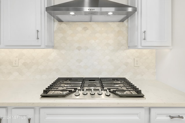 kitchen featuring white cabinetry, exhaust hood, and stainless steel gas stovetop