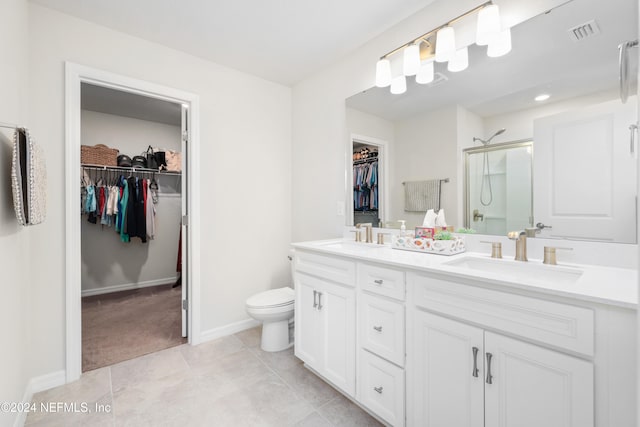 bathroom with vanity, tile patterned floors, toilet, and an enclosed shower