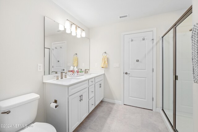 bathroom with walk in shower, vanity, toilet, and tile patterned floors