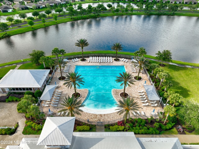 view of pool with a patio and a water view