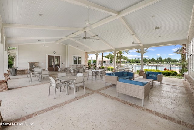 view of patio with an outdoor living space, a water view, and ceiling fan