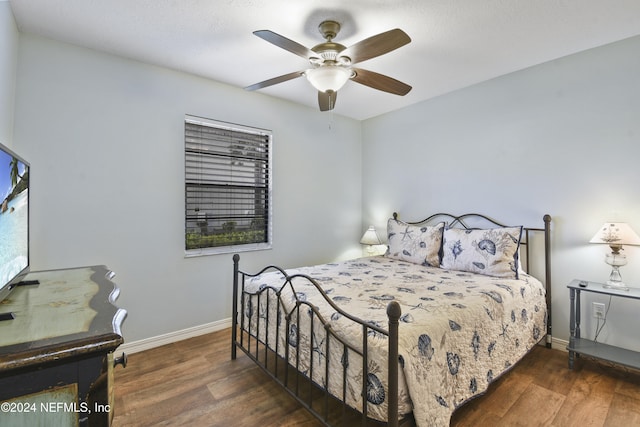 bedroom with ceiling fan and dark hardwood / wood-style flooring