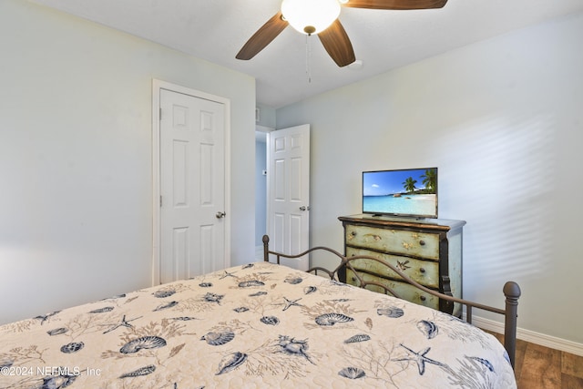 bedroom featuring hardwood / wood-style floors and ceiling fan