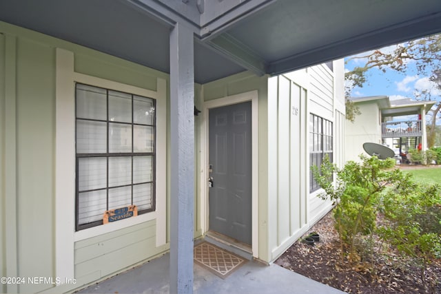 view of exterior entry with a porch