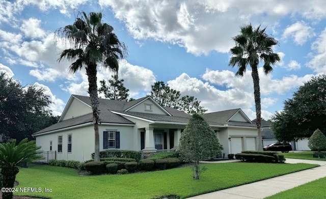 view of front of property with a garage and a front lawn