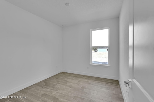 unfurnished room with light hardwood / wood-style floors