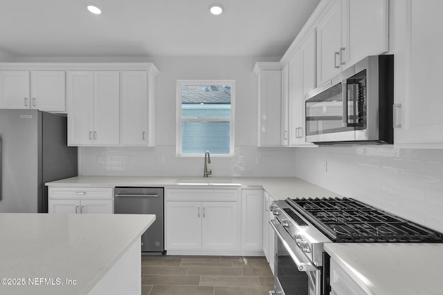 kitchen featuring sink, stainless steel appliances, and white cabinets