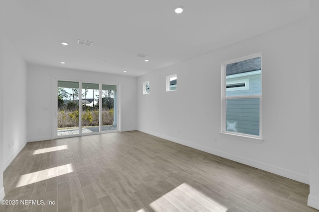 spare room featuring light hardwood / wood-style floors