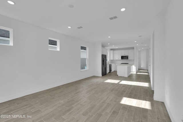 unfurnished living room featuring light hardwood / wood-style floors