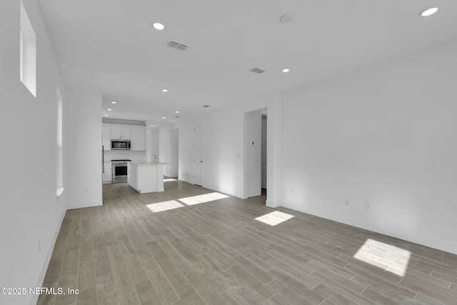 unfurnished living room featuring light hardwood / wood-style flooring