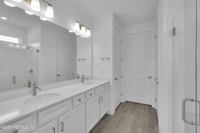 bathroom featuring vanity and an enclosed shower