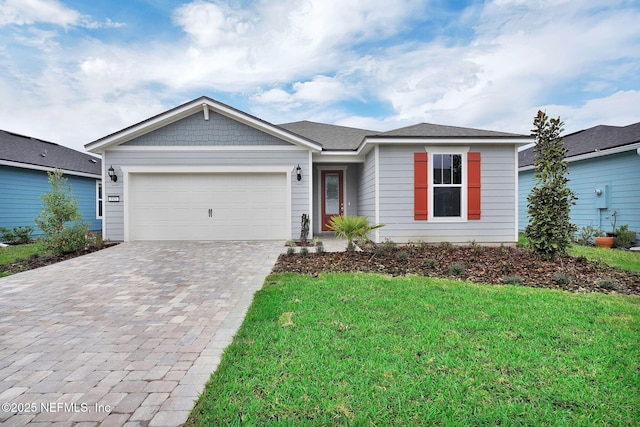 ranch-style home featuring a garage, a front lawn, and decorative driveway