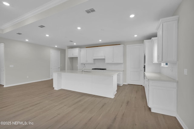 kitchen with visible vents, light wood-style flooring, white cabinetry, recessed lighting, and light countertops