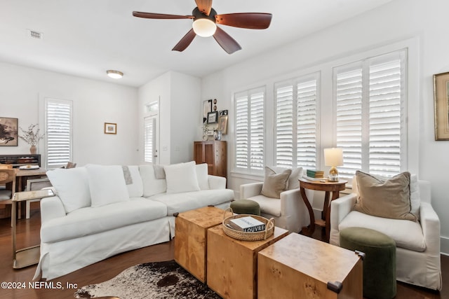 living room featuring dark hardwood / wood-style flooring and ceiling fan