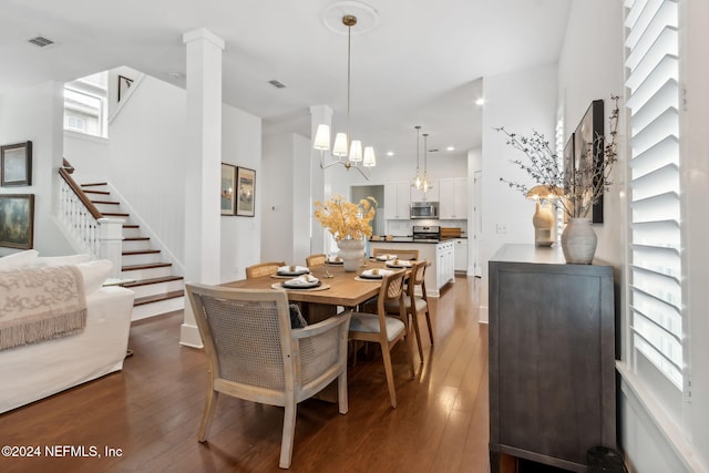 dining room featuring hardwood / wood-style flooring and a notable chandelier