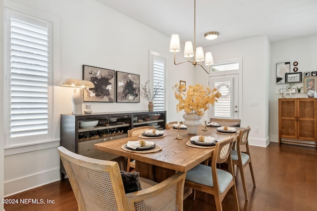 dining room featuring dark wood-type flooring and a notable chandelier