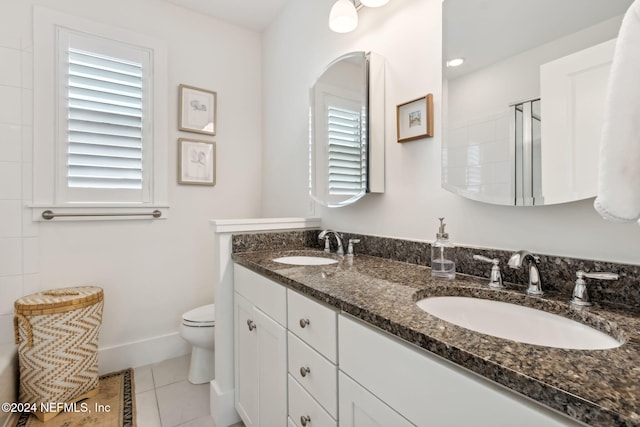 bathroom featuring walk in shower, tile patterned flooring, vanity, and toilet