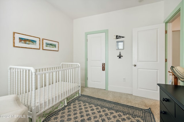 carpeted bedroom with a crib