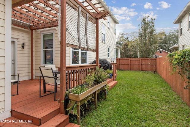 wooden terrace featuring area for grilling, a pergola, and a lawn