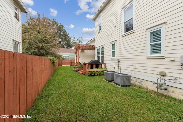 view of yard with a wooden deck, a pergola, and cooling unit