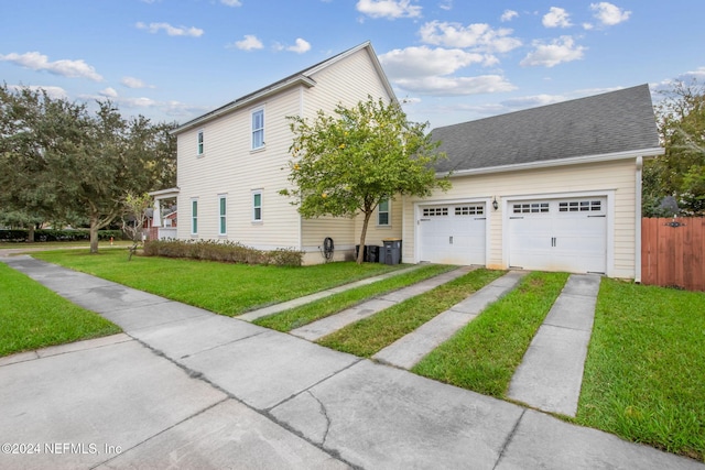 view of front of property featuring a garage and a front yard