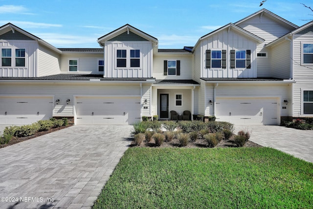 view of property with a front yard and a garage