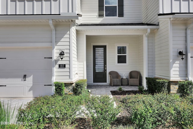 doorway to property with a garage