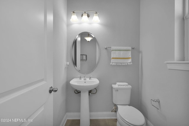 bathroom with toilet and tile patterned flooring